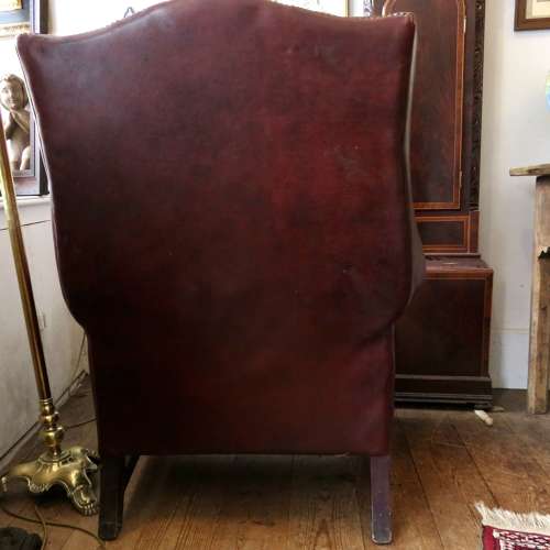 George III style ox-blood red leather wingback armchair