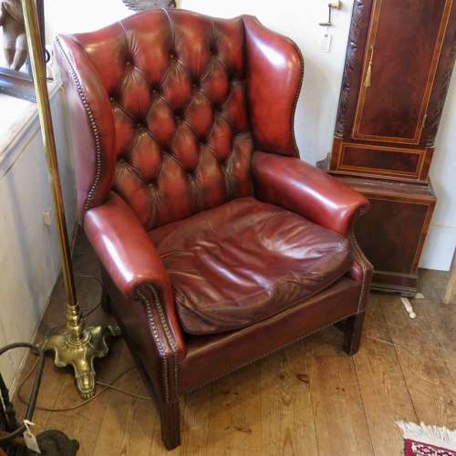 George III style ox-blood red leather wingback armchair