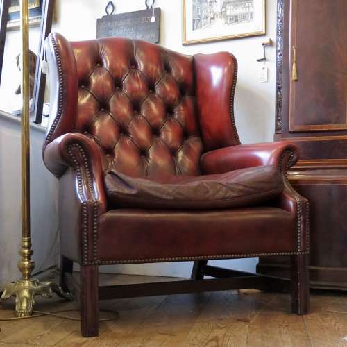 George III style ox-blood red leather wingback armchair