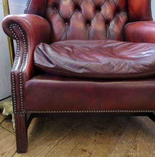George III style ox-blood red leather wingback armchair