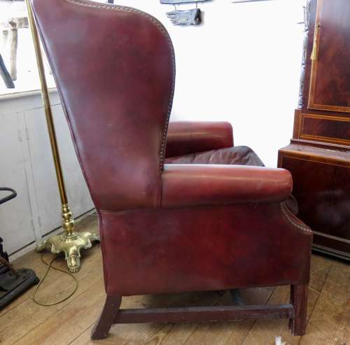 George III style ox-blood red leather wingback armchair