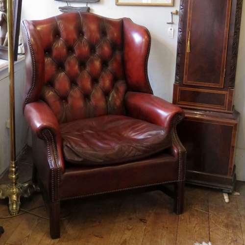 George III style ox-blood red leather wingback armchair
