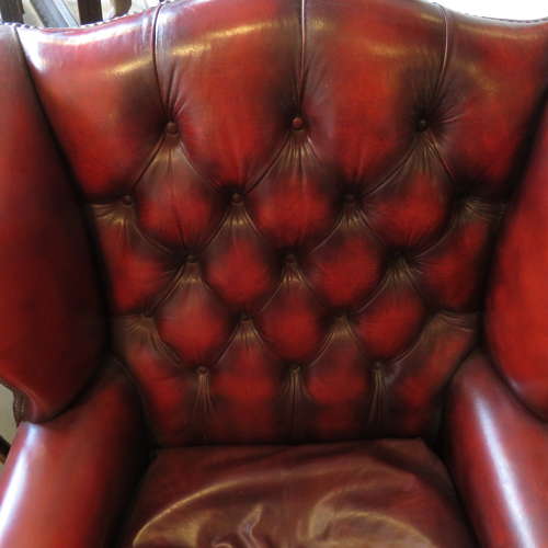 George III style ox-blood red leather wingback armchair