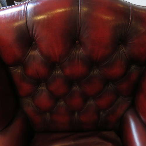 George III style ox-blood red leather wingback armchair