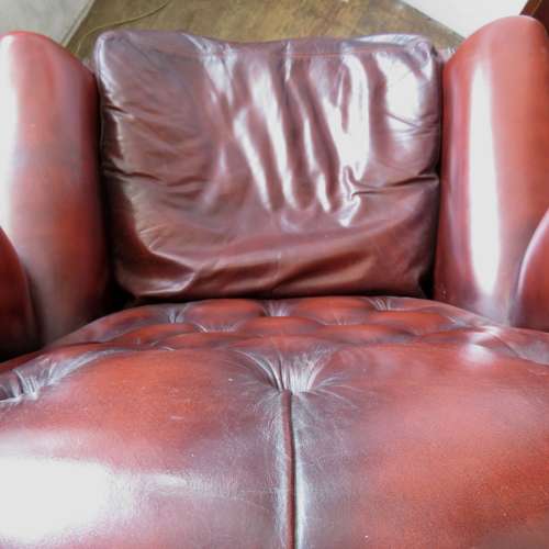 George III style ox-blood red leather wingback armchair