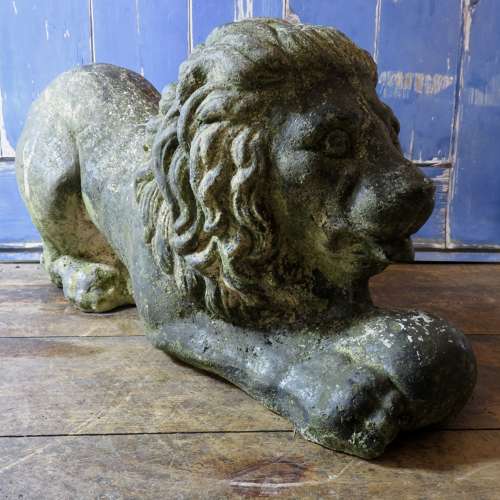 Stone (reconstituted) Lion lying with a ball