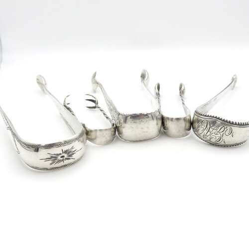 A group of five silver sugar nips - priced to go